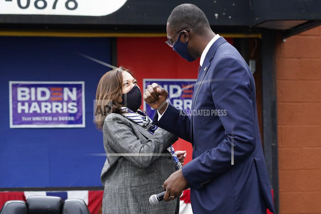 Paul Sancya Democratic vice presidential candidate Sen. Kamala Harris, D-Calif., and Michigan Lt. Gov. Garlin Gilchrist II greet one another at Headliners Barbershop in Detroit, Tuesday, Sept. 22, 2020. (AP Photo/Paul Sancya)