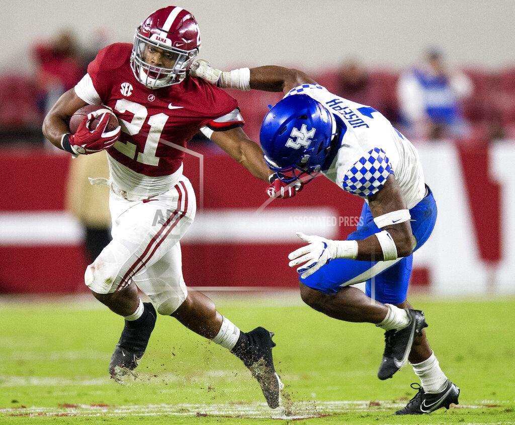 Alabama running back Jase McClellan (21) tries to fend off Kentucky defensive back Kelvin Joseph (1) during an NCAA college football game Saturday, Nov. 21, 2020, in Tuscaloosa, Ala. (Mickey Welsh/The Montgomery Advertiser via AP)