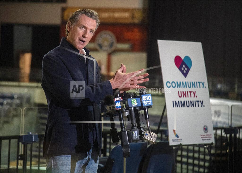 Clifford Oto FILE - In this April 15, 2021, file photo California Governor Gavin Newsom speaks at a press conference after touring the Stockton Vaccination Hub at the Stockton Arena in downtown Stockton, Calif. "This state is ready to come back, come roaring back," Gov. Gavin Newsom said Thursday during a news conference to announce all adults are now eligible to receive a COVID-19 vaccine. (Clifford Oto/The Record via AP File)