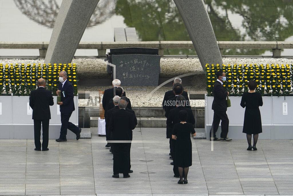 Eugene Hoshiko Participants gather at Hiroshima Memorial Cenotaph during the ceremony to mark the 75th anniversary of the bombing at the Hiroshima Peace Memorial Park in Hiroshima, western Japan Thursday, Aug. 6, 2020. (AP Photo/Eugene Hoshiko)