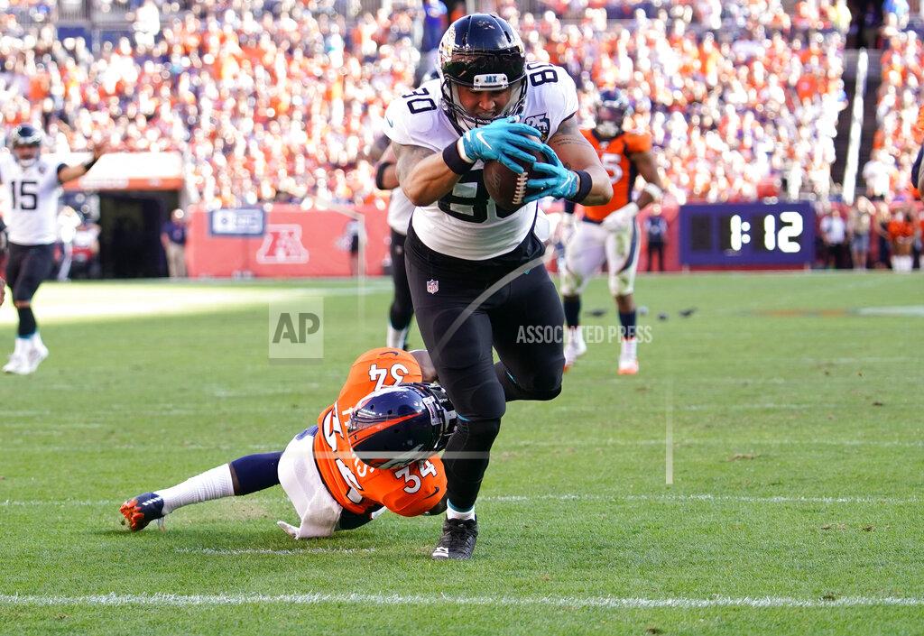 Jack Dempsey Jacksonville Jaguars tight end James O'Shaughnessy scores a touchdown as Denver Broncos strong safety Will Parks defends during the second half of an NFL football game Sunday, Sept. 29, 2019, in Denver. (AP Photo/Jack Dempsey)