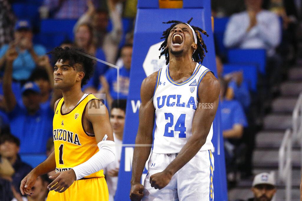 Ringo H.w. Chiu UCLA forward Jalen Hill (24) reacts after dunking against Arizona State guard Remy Martin (1) during the second half of an NCAA college basketball game Thursday, Feb. 27, 2020, in Los Angeles. (AP Photo/Ringo H.W. Chiu)