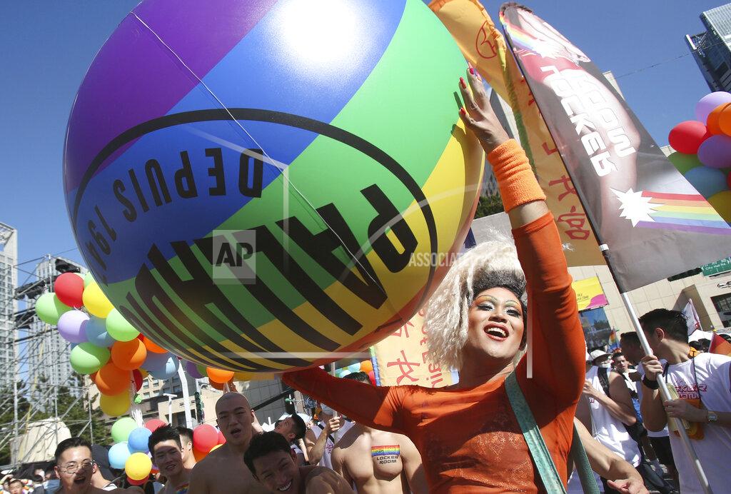 Chiang Ying-Ying Participants march through a street during a pride parade in Taipei, Taiwan, Saturday, Oct. 31, 2020. (AP Photo/Chiang Ying-ying)