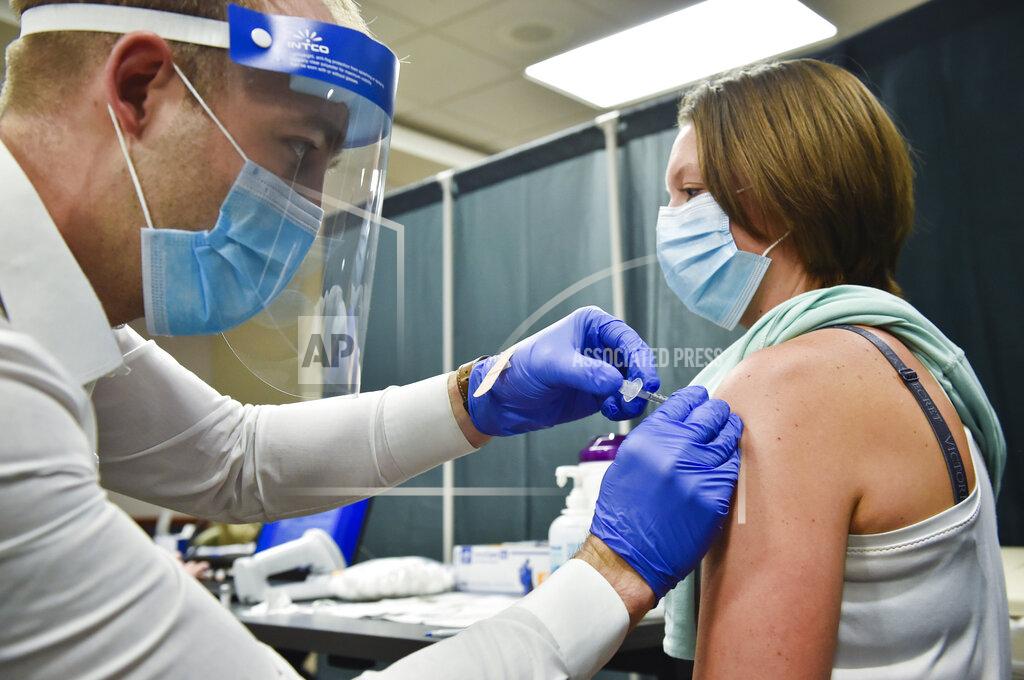 Thom Bridge Registered nurse Amy Brown receives the Pfizer-BioNTech COVID-19 vaccination on Wednesday, Dec. 16, 2020 at St. Peter's Health in Helena, Mont. (Thom Bridge/Independent Record via AP)