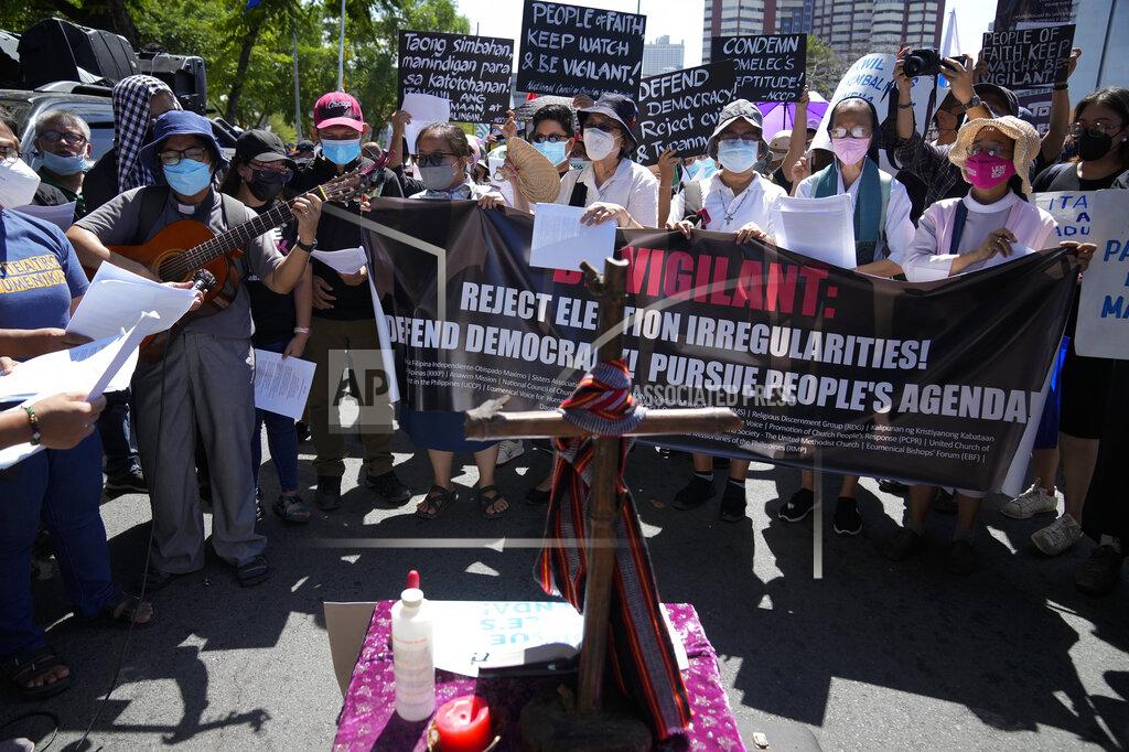 Aaron Favila Protesters pray during a rally against presidential frontrunner Ferdinand "Bongbong" Marcos and running mate Sara Duterte, daughter of the current president, during a rally in Pasay, Philippines on Friday, May 13, 2022. Allies of the Philippines' presumptive next president, Ferdinand "Bongbong" Marcos Jr., appear set to strongly dominate both chambers of Congress, further alarming activists after the late dictator's son scored an apparent election victory that will restore his family to the seat of power. (AP Photo/Aaron Favila)