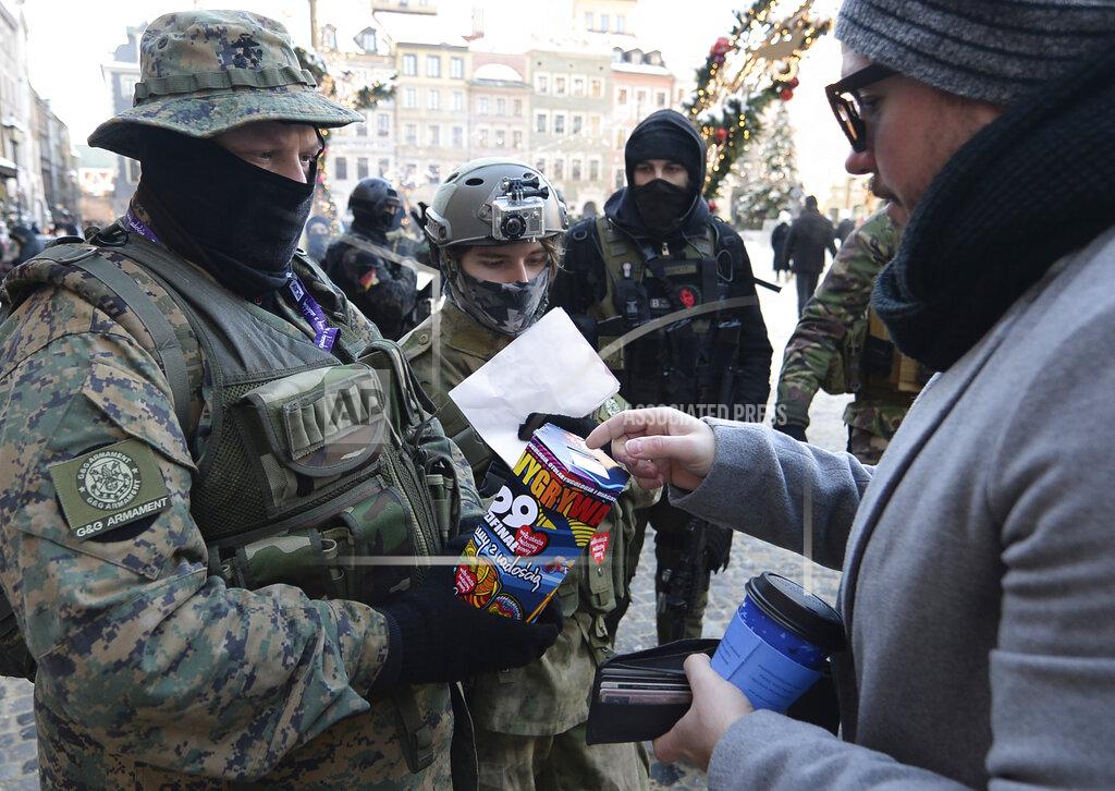 Czarek Sokolowski Military fans, dressed as soldiers collect money for Poland's most popular nationwide fundraiser for health purposes, the Great Orchestra of Christmas Charity, that was postponed by two weeks due to the pandemic, in downtown Warsaw, Poland, on Sunday, Jan. 31, 2021. Anti-government protesters angry about a near-total abortion ban suspended their marches for the weekend to show solidarity and ensure that they didn't steal the spotlight from the event. (AP Photo/Czarek Sokolowski)