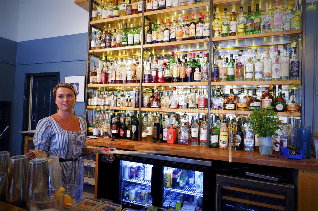 Ed Komenda Bartender Mallory Zeller poses for a photo at Kerouac's restaurant Wednesday, June 23, 2021 in rural Baker, Nev. along the Utah line. The eatery is owned by a couple that gave up urban life in New York City back in 2017 to move to to the remote area near Great Basin National Park. (Ed Komenda/The Reno Gazette-Journal via AP)