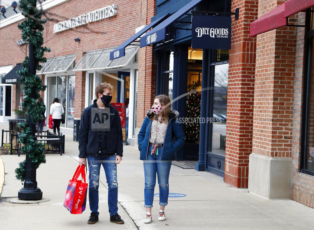 Brian Hill Andrew Czarnik, 17, and his sister Katherine Czarnik, 18, both of Deer Park, Ill., were happy to get good Black Friday deals at American Eagle Outfitters while shopping outdoors at Deer Park Town Center Friday, Nov. 27, 2020, in Deer Park, Ill. (Brian Hill/Daily Herald via AP)