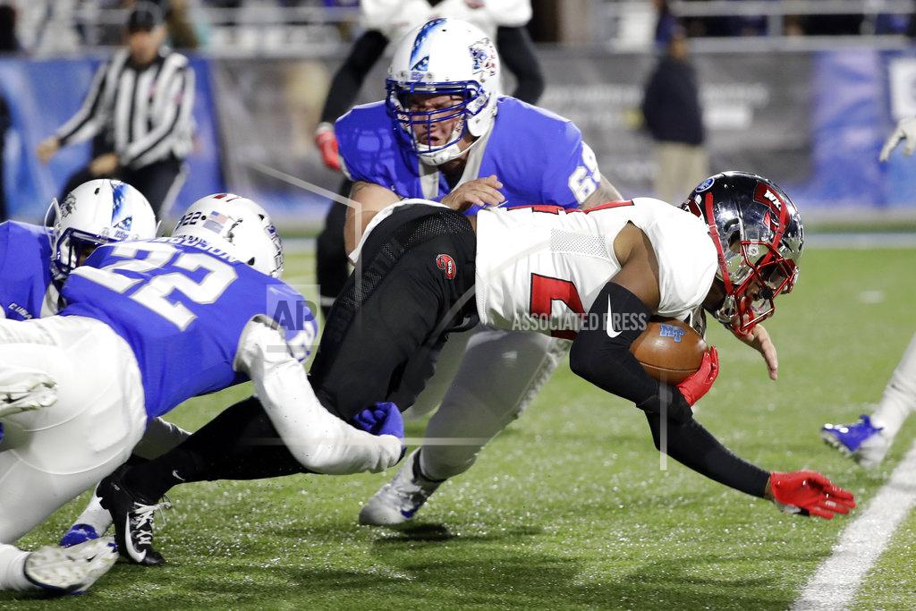 Mark Humphrey Western Kentucky kick-returner Roger Cray (24) is stopped by Middle Tennessee's Cordell Hudson (22) and Daniel Sargent (69) in the first half of an NCAA college football game Friday, Nov. 2, 2018, in Murfreesboro, Tenn. (AP Photo/Mark Humphrey)