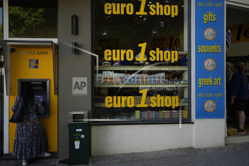 Thanassis Stavrakis A woman uses an ATM machine in the main town of the Aegean Sea island of Rhodes, southeastern Greece, Tuesday, May 10, 2022. Russia's war in Ukraine has accelerated inflation across Europe, with prices for energy, materials and food surging at rates not seen for decades. Inflation is expected to hit nearly 7% this year in the 27-nation EU and is contributing to slowing growth forecasts. (AP Photo/Thanassis Stavrakis)