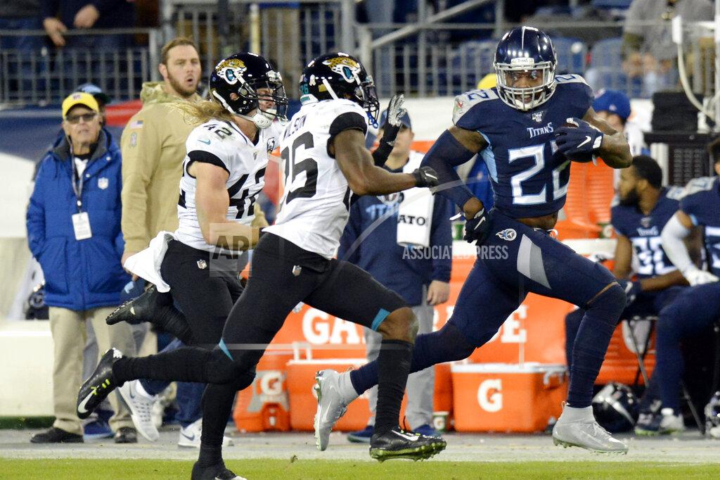 Mark Zaleski Tennessee Titans running back Derrick Henry (22) runs past Jacksonville Jaguars safety Jarrod Wilson (26) and safety Andrew Wingard (42) as Henry scores a touchdown on a 74-yard run in the second half of an NFL football game Sunday, Nov. 24, 2019, in Nashville, Tenn. (AP Photo/Mark Zaleski)
