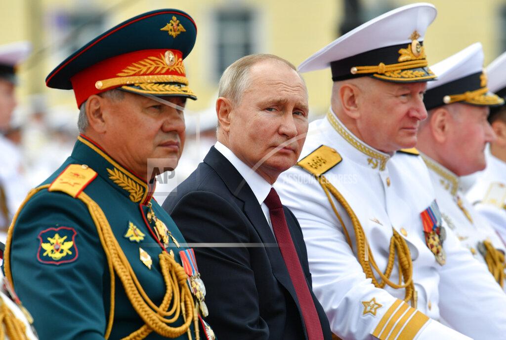 Alexei Nikolsky Russian President Vladimir Putin, center, Admiral Nikolai Yevmenov, Commander-in-Chief of the Russian Navy, second right, and Russian Defense Minister Sergei Shoigu, left, watch the Navy Day parade in St.Petersburg, Russia, Sunday, July 25, 2021. (Alexei Nikolsky, Sputnik, Kremlin Pool Photo via AP)