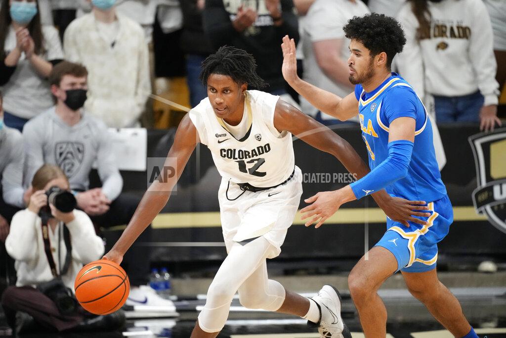 David Zalubowski Colorado forward Jabari Walker, left, is defended by UCLA guard Johnny Juzang during the second half of an NCAA college basketball game Saturday, Jan. 22, 2022, in Boulder, Colo. UCLA won 71-65. (AP Photo/David Zalubowski)