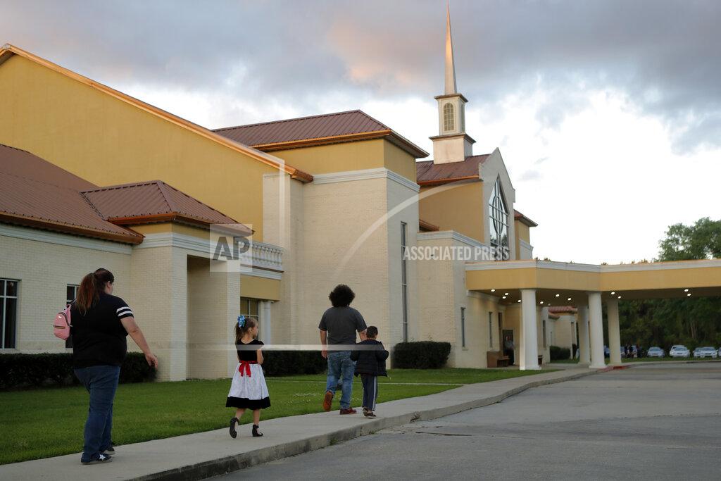 Gerald Herbert FILE - In this March 31, 2020 file photo, congregants arrive for evening service at the Life Tabernacle Church in Central, La. Pastor Tony Spell held services despite being charged with misdemeanors for holding services against Gov. John Bel Edwards shelter-in-place order due to the new coronavirus pandemic. Where political divides marred early recovery efforts after Hurricane Katrina in 2005, Louisiana is showing rare political unity in the fight against the new coronavirus. (AP Photo/Gerald Herbert, File)
