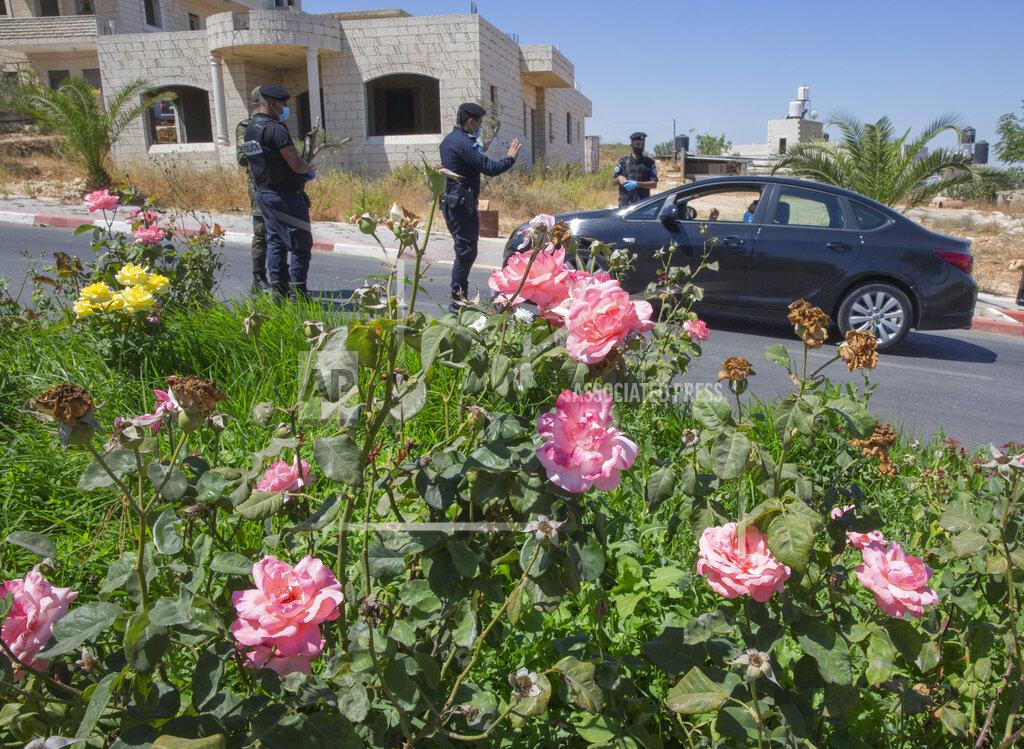 Nasser Nasser A Palestinian security unit mans a checkpoint at an entrance of in the West Bank city of Ramallah, Thursday, July 2, 2020. The Palestinian Authority has announced a five-day total lockdown in the West Bank starting Friday, in response to a major increase in coronavirus cases and deaths in recent days. (AP Photo/Nasser Nasser)