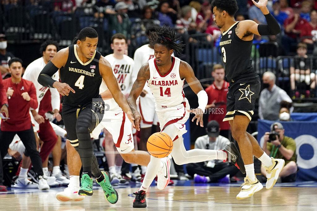 Chris O'meara Alabama guard Keon Ellis (14) runs between Vanderbilt forward Jordan Wright (4) and Rodney Chatman (3) during the first half of an NCAA men's college basketball Southeastern Conference tournament game Thursday, March 10, 2022, in Tampa, Fla. (AP Photo/Chris O'Meara)