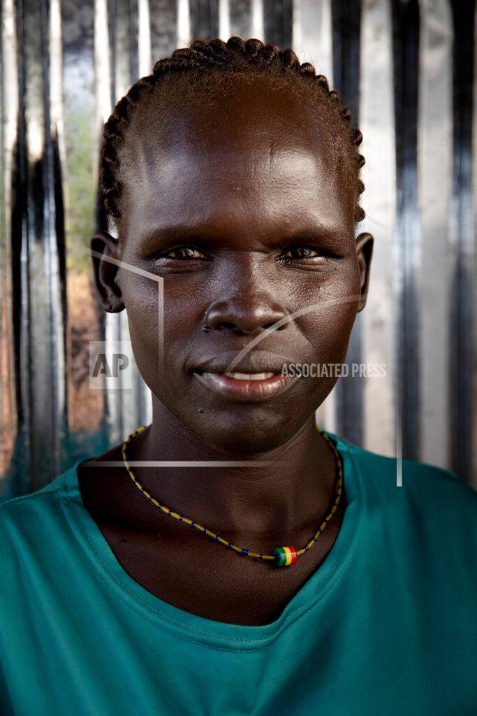 Adrienne Surprenant Oum Djima, 32-years-old mother of 5, poses for a portrait at Paska Itwari Beda's Juba, South Sudan home, Saturday, May 29, 2021. With resources scarce, Beda and nine women formed a group that meets and contributes two of the barest necessities for warding off hunger and illness _ money and bars of soap.They gather on Fridays, pooling supplies and handing them out to a different family every week. Over coffee, they share advice. (AP Photo/Adrienne Surprenant)