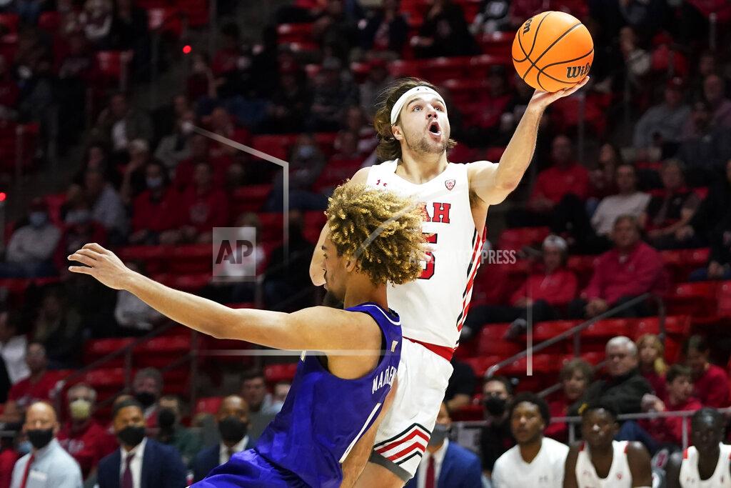 Rick Bowmer Utah guard Rollie Worster goes to the basket as Washington forward Emmitt Matthews Jr. defends during the second half of an NCAA college basketball game Thursday, Jan. 6, 2022, in Salt Lake City. (AP Photo/Rick Bowmer)