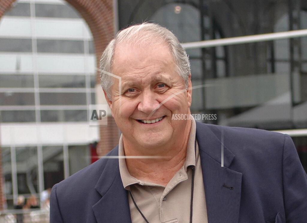 Joe Raymond FILE - In this Aug. 10, 2006, file photo, Jim Houston, smiles as he walks through a reception for players being enshrined into the College Football Hall of Fame, in South Bend, Ind. Houston's widow would keep notes on her husband's deteriorating condition in a three-ring binder so she would be prepared for the day when he needed full-time care. (AP Photo/Joe Raymond, File)