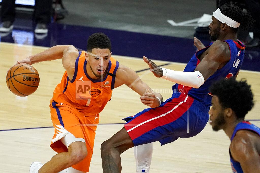 Matt York Phoenix Suns guard Devin Booker (1) fouls Detroit Pistons forward Jerami Grant during the second half of an NBA basketball game, Friday, Feb. 5, 2021, in Phoenix. (AP Photo/Matt York)