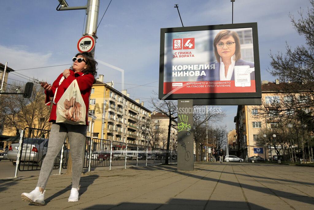 Valentina Petrova A woman walks by a poster of Bulgarian Socialists' Party leader Kornelia Ninova in Sofia, Bulgaria, Wednesday, March 31, 2021. After months of nationwide anti-government protests over corruption, stalled reforms and a stagnating economy in the EU's poorest member state, Bulgarians are gearing up for a parliamentary election overshadowed by a deadly pandemic. (AP Photo/Valentina Petrova)