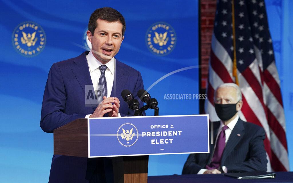 Kevin Lamarque Former South Bend, Ind. Mayor Pete Buttigieg, President-elect Joe Biden's nominee to be transportation secretary reacts to his nomination as Biden looks on during a news conference at The Queen theater in Wilmington, Del., Wednesday, Dec. 16, 2020. (Kevin Lamarque/Pool via AP)