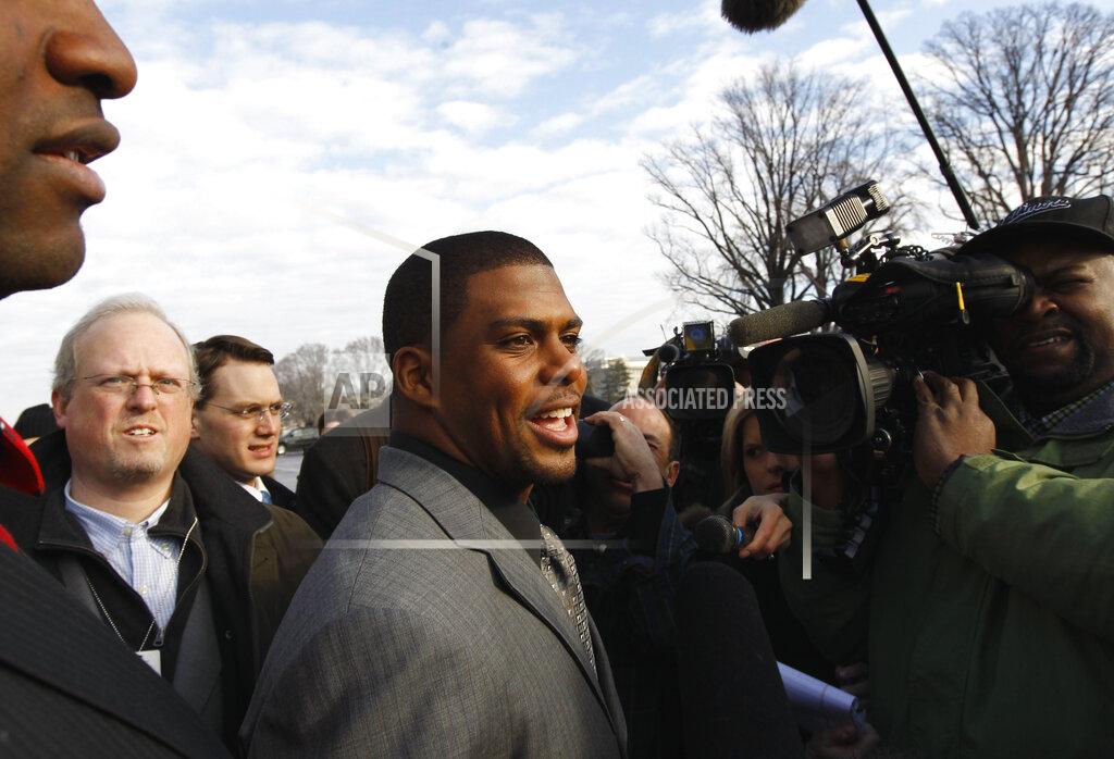 FILE - In this Jan. 19, 2011, file photo, Arizona Cardinals running back Jason Wright, center, talks to the media on Capitol Hill in Washington. The Washington Football Team has hired Jason Wright as team president. He’s the first Black person to hold this job in NFL history and at 38 becomes the youngest team president in the league. (AP Photo/Alex Brandon, File)
