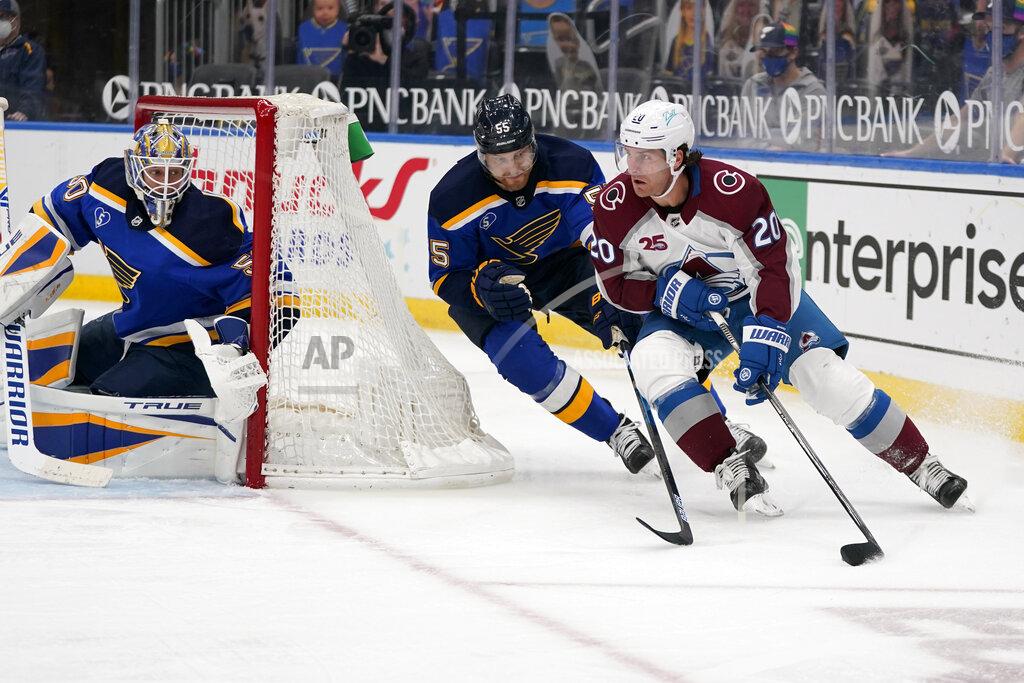Jeff Roberson Colorado Avalanche's Brandon Saad, right, handles the puck as St. Louis Blues goaltender Jordan Binnington, left, and Colton Parayko (55) defend during the third period of an NHL hockey game Thursday, April 22, 2021, in St. Louis. (AP Photo/Jeff Roberson)