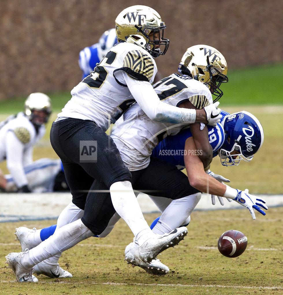 Ben Mckeown Duke's Jake Bobo (19) fumbles the ball after making a catch as Wake Forest's Nasir Greer, middle, and DJ Taylor, left, move in for a tackle during the second half of an NCAA college football game in Durham, N.C., Saturday, Nov. 24, 2018. (AP Photo/Ben McKeown)