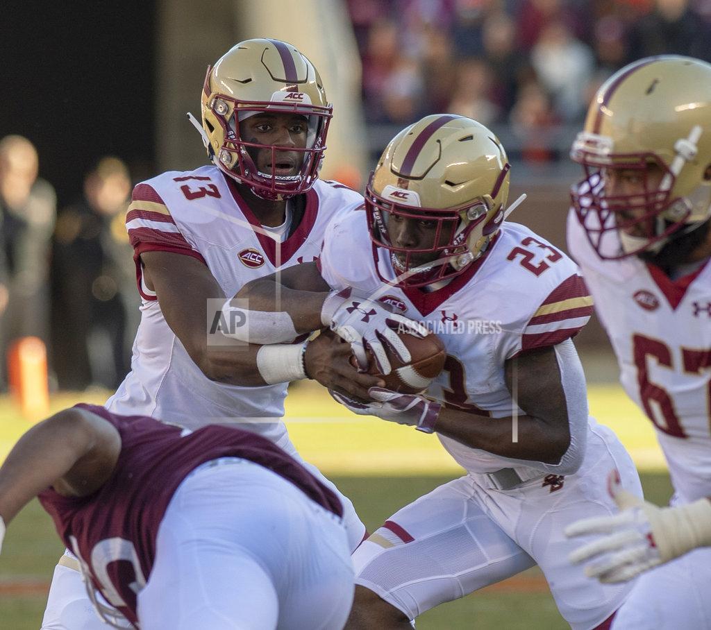 Matt Bell Boston College quarterback Anthony Brown hands the ball off to running back Travis Levy during the first half of an NCAA college football game against Virginia Tech in Blacksburg, Va., Saturday, Nov. 3, 2018. (AP Photo/Matt Bell)