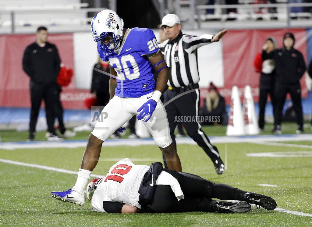 Mark Humphrey Middle Tennessee linebacker DQ Thomas (20) steps over Western Kentucky quarterback Steven Duncan (10) after knocking him down during the second half of an NCAA college football game Friday, Nov. 2, 2018, in Murfreesboro, Tenn. Middle Tennessee won 29-10. (AP Photo/Mark Humphrey)