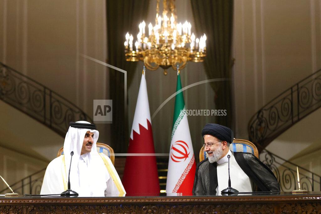 Uncredited In this photo released by the official website of the office of the Iranian Presidency, President Ebrahim Raisi, right, and Qatari Emir Sheikh Tamim bin Hamad Al Thani talk during their joint press briefing at the Saadabad Palace in Tehran, Iran, Thursday, May 12, 2022. Qatar's emir arrived in Tehran for talks with the Iranian president as efforts to save Tehran's tattered nuclear deal with world powers hit a deadlock. (Iranian Presidency Office via AP)