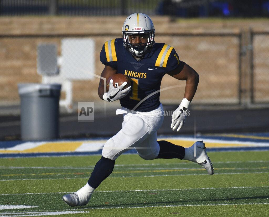 In this undated image provided by Marian University, Indianapolis Athletics, Marian running back Charles Salary carries the ball during a college football game in Carmel, Ind. Player of the year Charles Salary from Marian and fellow running back Arnijae Ponder of Morningside lead The Associated Press NAIA All-America team. (Joe Gilbert/Marian University, Indianapolis Athletics via AP)