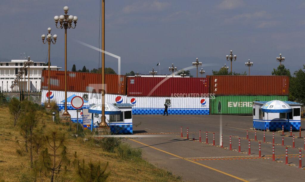 Anjum Naveed Shipping containers placed by authorities block a road leading to important government buildings in an attempt to foil a planned rally by Pakistan's key opposition party, in Islamabad, Pakistan, Tuesday, May 24, 2022. Pakistan banned ousted Prime Minister Imran Khan from holding a massive rally in the capital of Islamabad and cracked down on his supporters in overnight raids across the country, arresting hundreds. (AP Photo/Anjum Naveed)