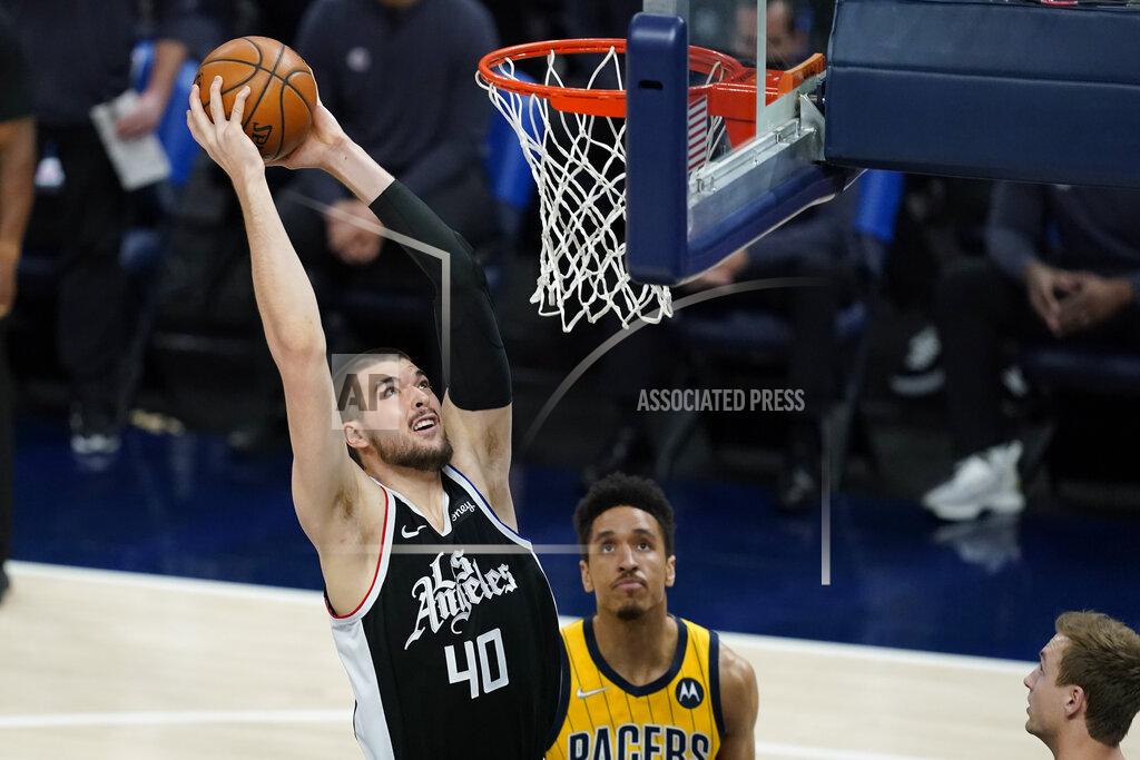 Darron Cummings Los Angeles Clippers' Ivica Zubac (40) goes up for a dunk against Indiana Pacers' Malcolm Brogdon (7) during the first half of an NBA basketball game, Tuesday, April 13, 2021, in Indianapolis. (AP Photo/Darron Cummings)