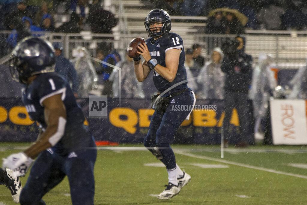 Tom R. Smedes Nevada quarterback Carson Strong (12) looks to pass the ball in the rain against Hawaii in the first half of an NCAA college football game in Reno, Nev., Saturday, Sept. 28, 2019. (AP Photo/Tom R. Smedes)