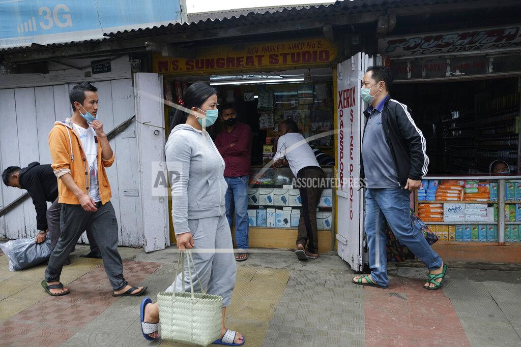 Yirmiyan Arthur People walk past a market area in Kohima, capital of the northeastern Indian state of Nagaland, Friday, May 22, 2020. India’s central bank on Friday cut its key interest rate to 4% to counter the blow to the economy from the coronavirus pandemic and a lockdown meant to contain it. The restrictions are scheduled to last through the end of May, but some have been relaxed, with shops gradually reopening and manufacturing and farming resuming. (AP Photo/Yirmiyan Arthur)