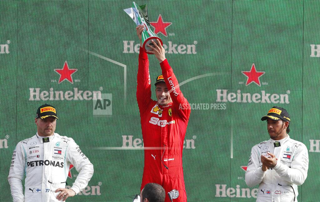 Ferrari driver Charles Leclerc of Monaco, center, celebrates with runner-up Mercedes driver Valtteri Bottas of Finland, left, and third placed Mercedes driver Lewis Hamilton of Britain, on podium after winning the Formula One Italy Grand Prix at the Monza racetrack, in Monza, Italy, Sunday, Sept.8, 2019. (AP Photo/Antonio Calanni)