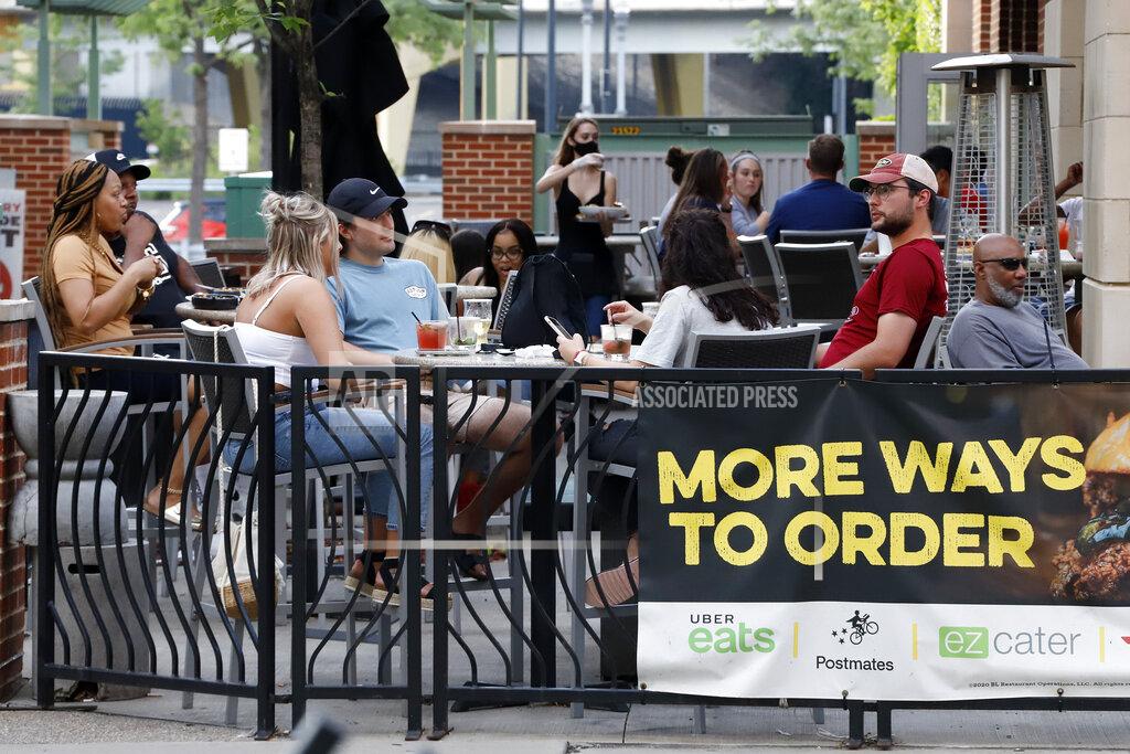 Gene J. Puskar People gather at tables outside Bar Louie in Pittsburgh on Sunday, June 28, 2020. In response to the recent spike in COVID-19 cases in Allegheny County, health officials are ordering all bars and restaurants in the county to stop the sale of alcohol for on-site consumption beginning Tuesday afternoon. (AP Photo/Gene J. Puskar)