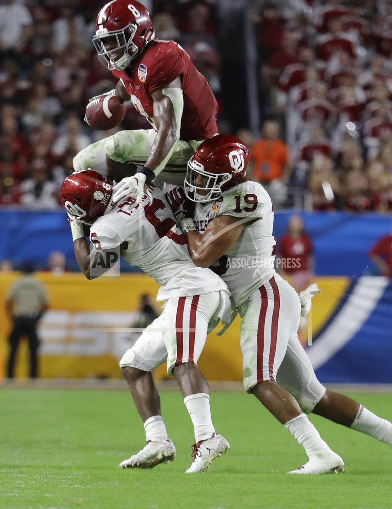 Lynne Sladky Alabama running back Josh Jacobs (8) jumps over Oklahoma cornerback Tre Brown (6) and linebacker Caleb Kelly (19), during the first half of the Orange Bowl NCAA college football game, Saturday, Dec. 29, 2018, in Miami Gardens, Fla. (AP Photo/Lynne Sladky)