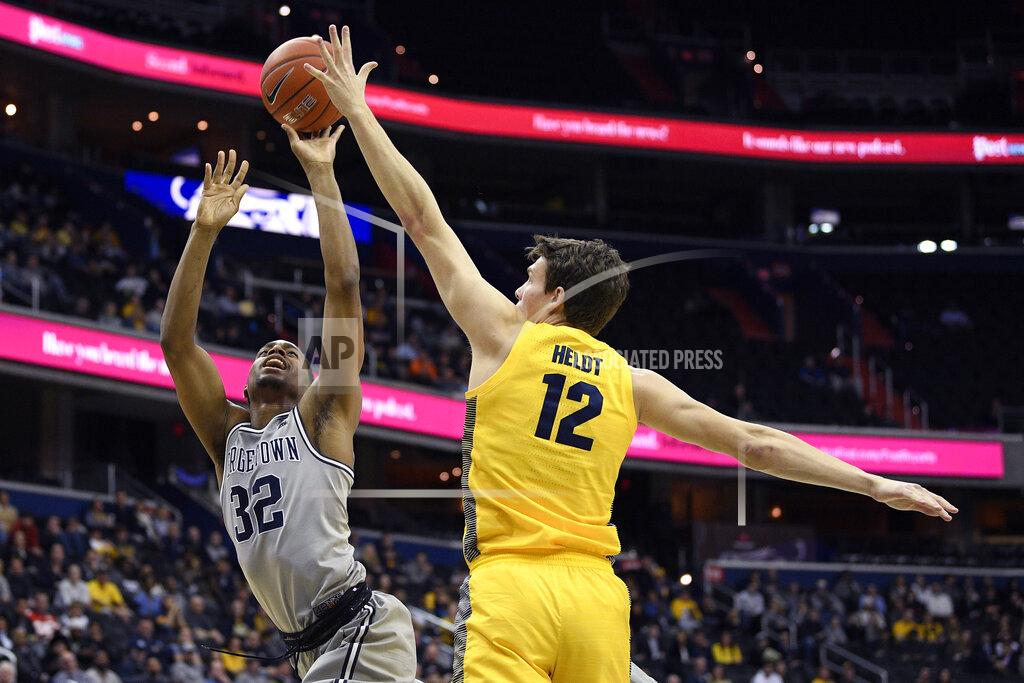 Nick Wass Georgetown guard Kaleb Johnson (32) goes to the basket against Marquette center Matt Heldt (12) during the second half of an NCAA college basketball game, Tuesday, Jan. 15, 2019, in Washington. Marquette won 74-71. (AP Photo/Nick Wass)