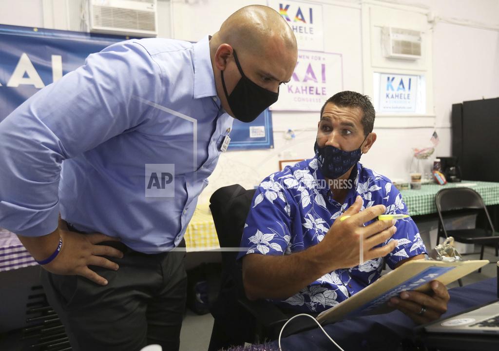 Kelsey Walling U.S. House of Representatives candidate Kai Kahele talks with his statewide field coordinator Micah Alameda while writing speeches at his Hilo, Hawaii, headquarters on Tuesday, Nov. 3, 2020. Kahele will be monitoring election results through the night. (Kelsey Walling/Hawaii Tribune-Herald via AP)
