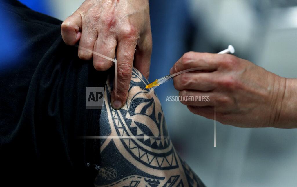 Petr David Josek A tattooed person gets Pfizer vaccine at the National vaccination center in Prague, Czech Republic, Friday, April 9, 2021. On Friday the center, that is the biggest in the country, held its final trials before being able to vaccinate up to 10 000 people a day. (AP Photo/Petr David Josek)