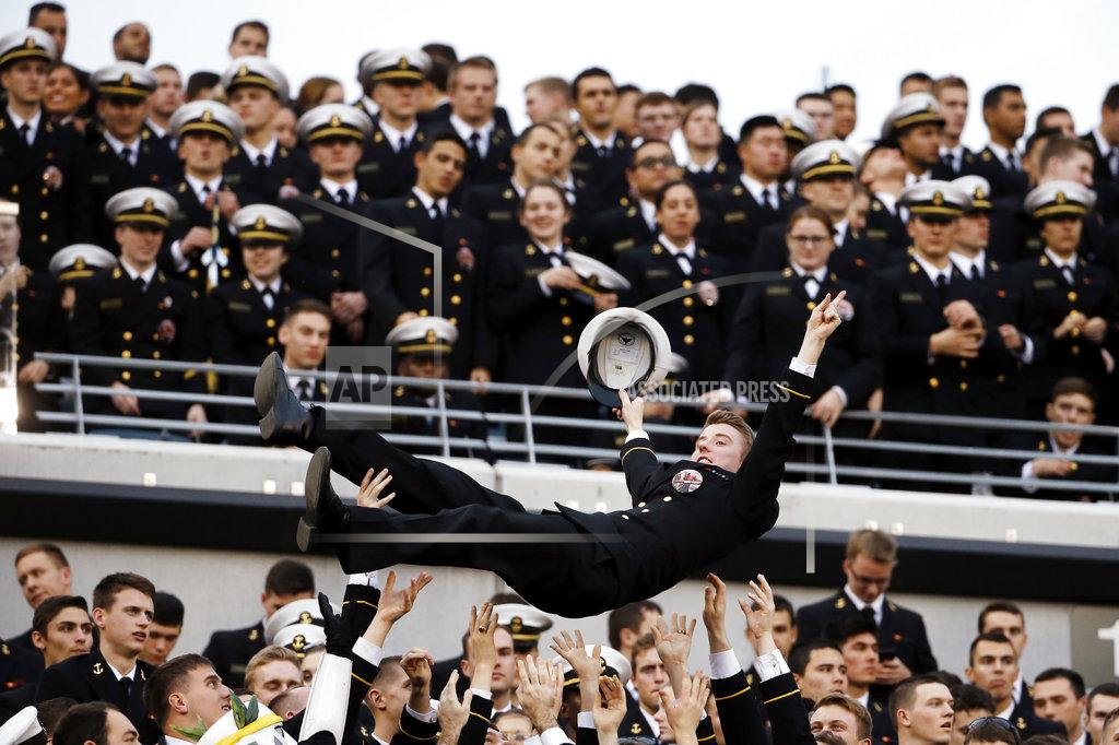 Matt Slocum FILE - In this Dec. 12, 2015, file photo, a Navy Midshipman is tossed in the air as Navy fans celebrate a touchdown during an NCAA college football game against Army, in Philadelphia. With Army ranked No. 22, the Cadets (9-2) try to beat Navy (3-9) for the third straight time Saturday, Dec. 8, 2018, in the storied series. (AP Photo/Matt Slocum)