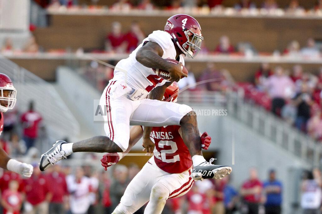 Michael Woods Alabama quarterback Jalen Milroe (4) tries to get past Arkansas linebacker Drew Sanders (42) during the second half of an NCAA college football game Saturday, Oct. 1, 2022, in Fayetteville, Ark. (AP Photo/Michael Woods)