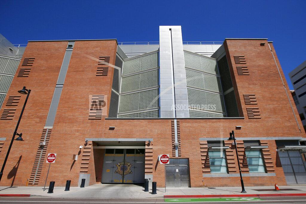 FILE - This March 21, 2020, file photo, shows the Maricopa County 4th Avenue Jail in downtown Phoenix. The number of inmates in Arizona's prisons and in some county jails in the state have decreased since the start of pandemic. The decrease reflects a slowdown in the state's court system that has held far fewer criminal jury trials over the last year as it took steps to prevent the coronavirus from spreading at courthouses. (AP Photo/Ross D. Franklin, File)