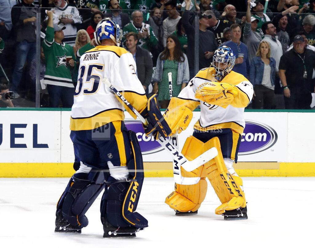 Tony Gutierrez FILE - In this April 17, 2019, file photo, Nashville Predators' Pekka Rinne (35) greets Juuse Saros, right, as Rinne leaves the game after giving up four goals to the Dallas Stars in the first period of Game 4 in an NHL hockey first-round playoff series in Dallas. The NHL's pause has the clock ticking on the career of a former Vezina Trophy winner and four-time finalist with Rinne turning 38 in November.(AP Photo/Tony Gutierrez, File)