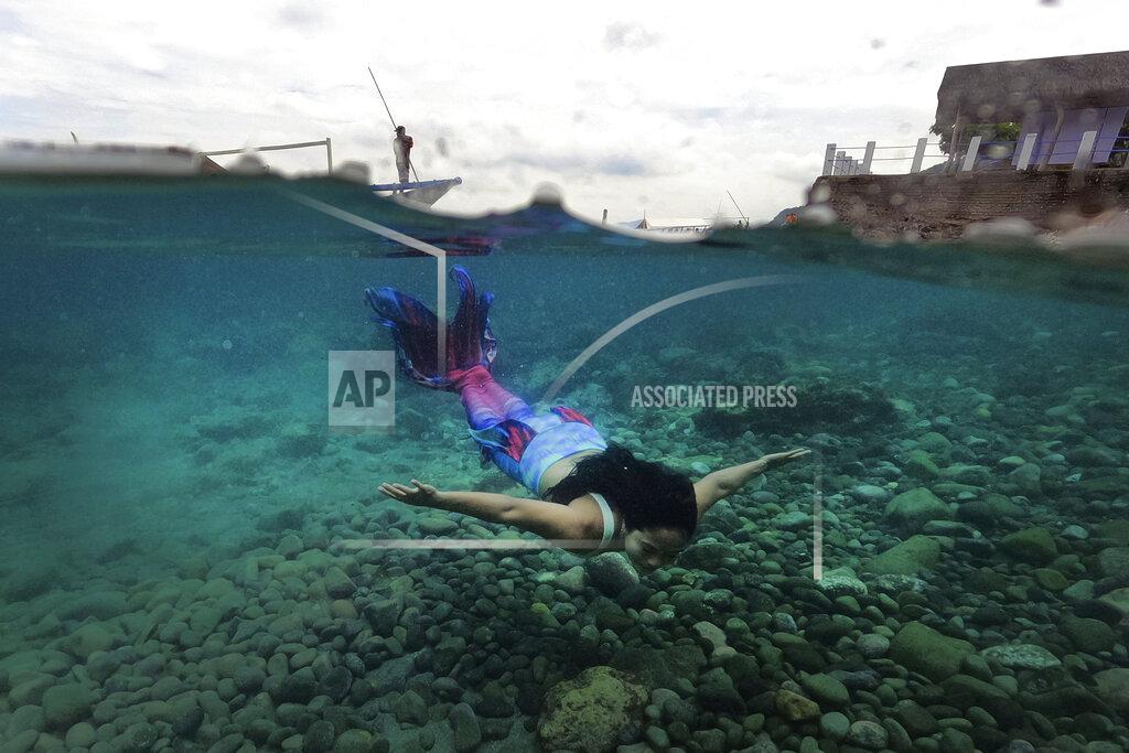 Aaron Favila Filipina Jennica Secuya swims in her mermaid suit during a mermaiding class in Mabini, Batangas province, Philippines on Sunday, May 22, 2022. (AP Photo/Aaron Favila)