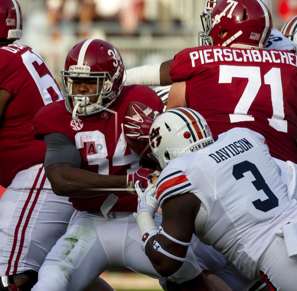Vasha Hunt Alabama running back Damien Harris (34) works by Auburn defensive lineman Marlon Davidson (3) during the first half of an NCAA college football game, Saturday, Nov. 24, 2018, in Tuscaloosa, Ala. (AP Photo/Vasha Hunt)