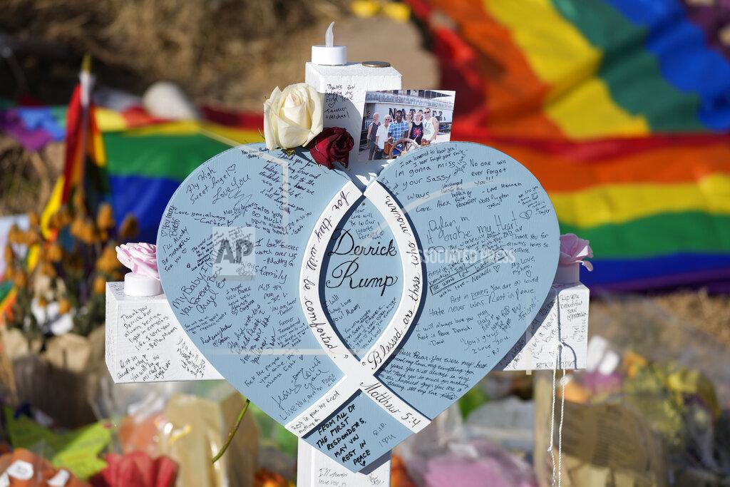 David Zalubowski Hand-written messages cover the heart attached to the cross to honor a victim of the mass shooting at a gay nightclub at a makeshift memorial near the scene of the crime Wednesday, Nov. 23, 2022, in Colorado Springs, Colo. The alleged shooter facing possible hate crime charges in the fatal shooting of five people at a Colorado Springs gay nightclub is scheduled to make their first court appearance Wednesday from jail after being released from the hospital a day earlier. (AP Photo/David Zalubowski)